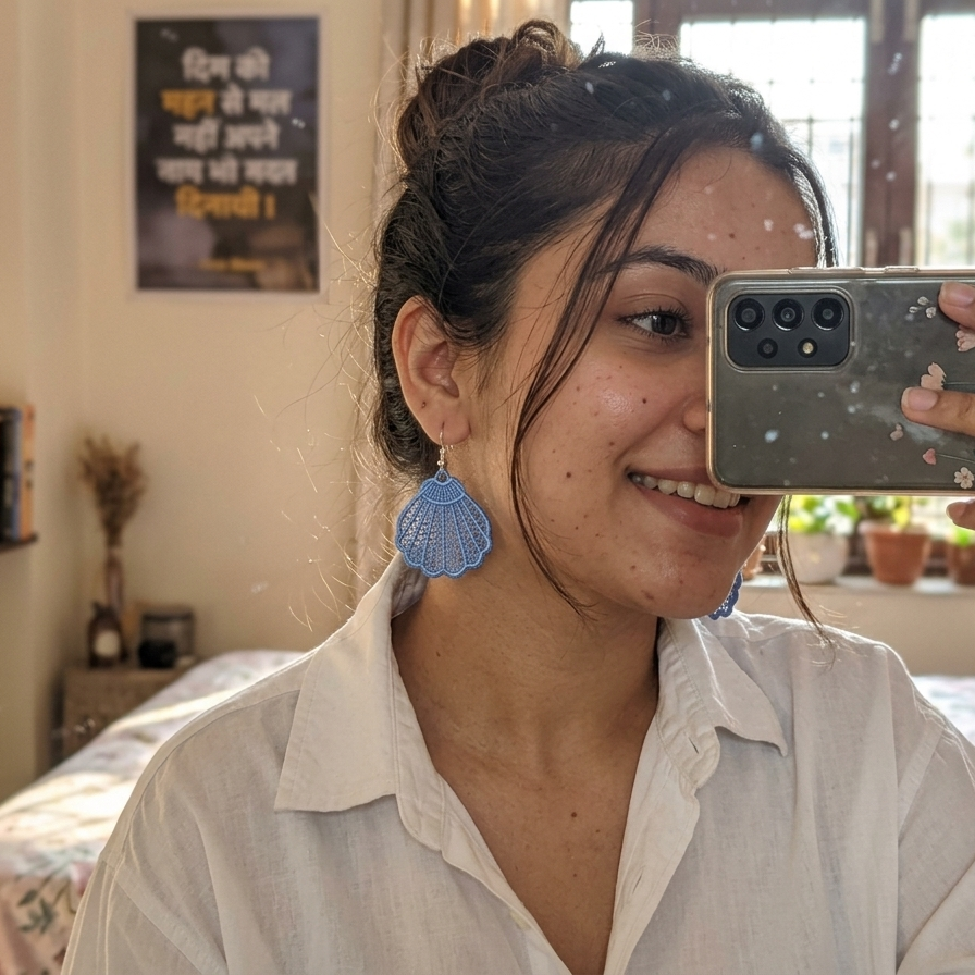 Woman taking a selfie in a room with books and decor.